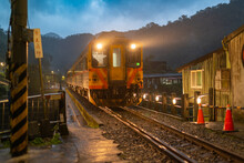 Trains With Lights On Are Moving In The Rain. Sandiaoling Railway Station, New Taipei City, Taiwan.  Translation "No Passing" By Chao Feng.