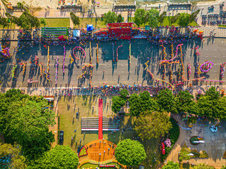 Wall Mural - Top view of dragon dance perform celebration new year. Group of people perform a traditional lion dance and dragon dance. Guinness record performance of 54 Dragons dance on the street Vung Tau.