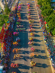 Wall Mural - Top view of dragon dance perform celebration new year. Group of people perform a traditional lion dance and dragon dance. Guinness record performance of 54 Dragons dance on the street Vung Tau.