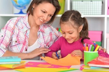 Wall Mural - Mother teaches her cute daughter to do craft items