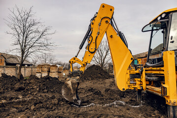 Wall Mural - An excavator digging soil on construction site.
