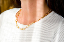 Close Up Woman With  Gold Necklace And Earrings