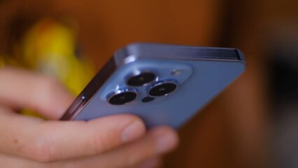 Male person typing sms message on modern blue smartphone. Guy texting online with mobile phone