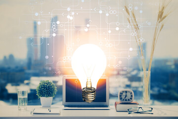 Aufkleber - Computer on desktop in office with bulb icon hologram. Double exposure. Concept of idea.
