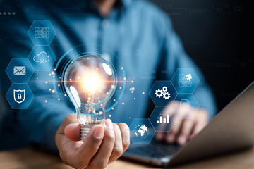 Leinwandbilder - Hand holding Light bulb planning development leadership and customer target group with Business global internet connection technology and digital marketing, Financial and banking, Digital link tech.