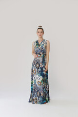 Wall Mural - Serie of studio photos of young female model in colorful tropical print sleeveless wrap dress