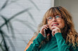 © carballo - pretty middle-aged woman talking on mobile phone at home