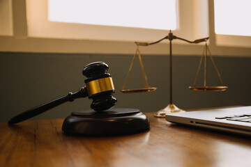 Business and lawyers discussing contract papers with brass scale on desk in office. Law, legal services, advice, justice and law concept picture with film grain effect