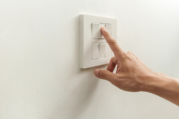 Poster - Closeup of finger is turning off on main control lighting switch on white wall at home. Power, Energy, Saving Electrical, Copy space.