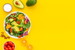 © 9dreamstudio - Top view of served green salad with avocado and tomatoes