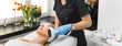 © PoppyPix - Wide shot of a beauty salon with a beautician doing thermolifting facial on her client's face. Beauty concept. High quality photo