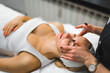 © PoppyPix - High angle shot of a woman receiving a face massage from a beautician. Beauty concept. High quality photo