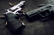 handgun and bullets, gun lies on a dark texture background close-up
