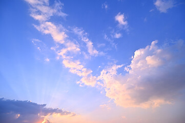 Wall Mural - sunset or sun rise sky with rays of light shining clouds and sky background and texture