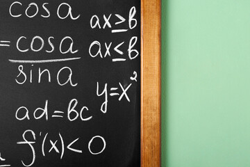 Wall Mural - Chalkboard with many different math formulas on green wall, closeup