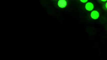 Wall Mural - Green Bokeh Lines Rapidly Falling Diagonally. Looped 4K video. Lines of green circles move randomly along the frame. Natural lens flare effect of defocused lights.