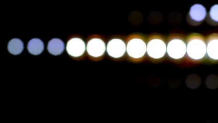 Wall Mural - Glowing dotted bokeh lines running horizontally across a black background. 4K Loop Abstract straight line dot run on the screen. Laser light dots stripe light technology background. Disco wall. 