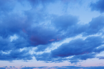 beautiful sunset sky with amazing colorful clouds against deep blue