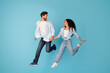 © Prostock-studio - Smiling excited surprised young european couple running, jumping, freeze in air to copy space
