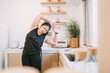 © tai - fat woman stretching arms improve movement. chubby woman focus warming before or after exercising reduce muscle tension. relax chubby woman training home fitness trying twisting arms for stretching