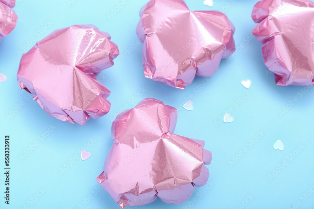 Pink balloons with hearts on blue background. Valentine's Day celebration