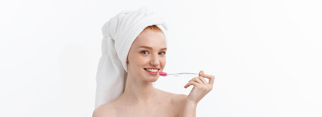 Wall Mural - Portrait of young woman with toothbrush on grey background.