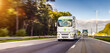 Hydrogen powered H2 Cargo semi truck driving on a highway. White Truck delivers goods in early hours of the Morning - very low angle drive thru close up shot -  motion blur effect