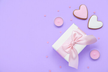 Wall Mural - Gift with cookies, candles and hearts on lilac background. Valentine's Day celebration