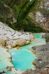 Hot springs at Bagni San Filippo, with calcium carbonate deposits surrounding the thermal water
