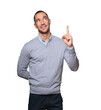 © agongallud - Happy young man pointing up with his finger