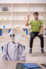 Wall Mural - Young male patient visiting skeleton doctor