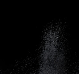 Million of black sand explosion, Photo image of falling down sands flying. Freeze shot on black background isolated overlay. Tiny Fine sand dust magnet as particle disintegrate science