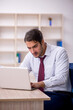 © Elnur - Young male employee and too much work in the office