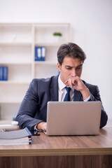 Young male employee working in the office