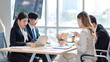 © Bangkok Click Studio - Millennial Asian young professional successful male female businessmen businesswomen employee in formal suit sitting smiling discussing communicating together in company office meeting room workplace