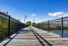 Pedestrian Bridge With Wooden Deck And Metal Railings In Manchester New Hampshire