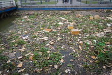 Toned Photo Pollution In The Saigon River Near Pier On Bach Dang Wharf Blanketed In Plastic Bottles, Styrofoam Boxes, Cups