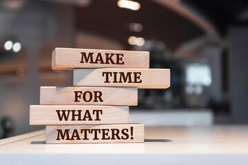 Wooden blocks with words 'Make time for what matters!'.