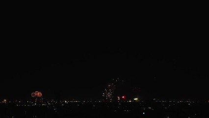 Wall Mural - Slow Motion Distanced Fireworks at Wide Night City Landscape