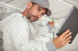 © auremar - pensive young worker using pc tablet computer while working indoors