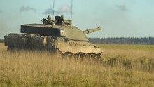 Rear Quarter Profile Of British Army FV4034 Challenger 2 Ii Main Battle Tank In Action On A Military Combat Exercise, Wiltshire UK