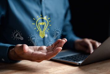 Aufkleber - Businessman using computer holding light bulb icon which for mind, creative, idea, innovation, motivation planning development leadership and customer target group concept..