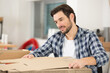 © auremar - male worker assembling a cardboard box from a template