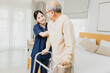 © khwanchai - Elderly patient physiotherapy nurse exercising and try to walk