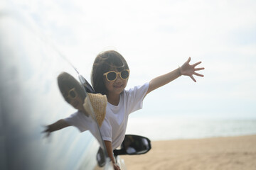 Wall Mural - Hand out car window. Happy travel at beach. Family in car happy together enjoy with traveling. gesture happy travel images