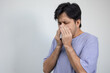 © anut21ng Stock - portrait asian man coughing and sneezing