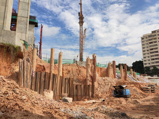 Wall Mural - MELAKA, MALAYSIA -JUNE 19, 2022: A view of a construction site in full swing. Machines and workers are busy doing work. The safety level is ensured to reach the required standards.