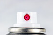 Pink acrylic spray paint white plastic cap on a metal can close up on light background with copy space.