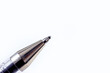 Metal ballpoint pen on light background close up with copy space.