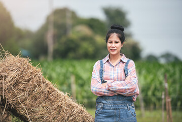 Portrait of attractive asian woman standing and crossed arms with confident, New generation agricultural smart farmer working in dairy farm, Livestock and farm industry lifestyle.